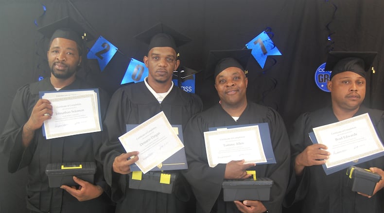 Four fathers — Johnathan Solomon, Demario Dargan, Tommy Allen and Brad Edwards — celebrate their completion of the Parental Accountability Court in Milledgeville, which gives parents the tools to make child support payments on time and keeps them out of jail. Courtesy photo.