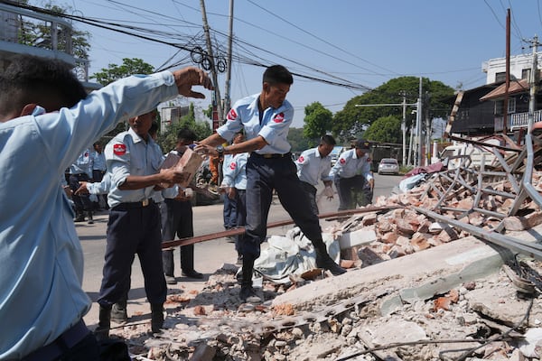 Myanmar's military officers search through rubble of a collapsed building following Friday's earthquake in Naypyitaw, Myanmar, Tuesday, April 1, 2025. (AP Photo)