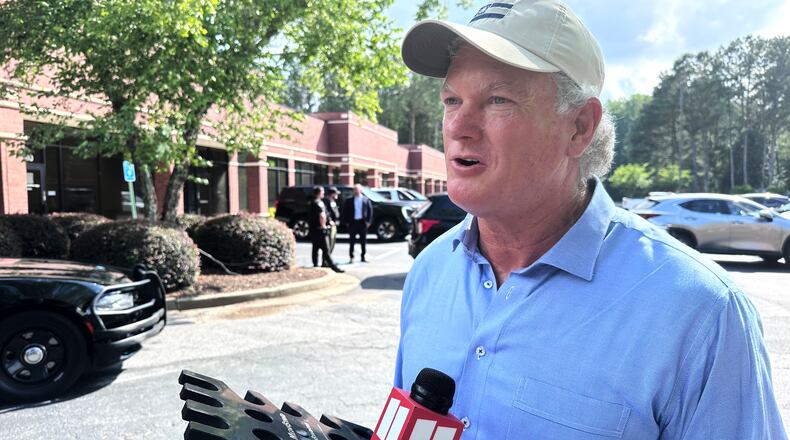 U.S. Rep Mike Collins campaigns in Woodstock, Ga., Sunday, June 14, 2026. ( AP Photo/Bill Barrow)