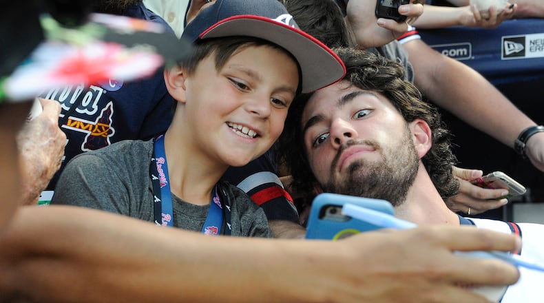 Dansby Swanson of the Braves, right, poses with 9-year-old fan Caleb Zurawick of Chattanooga, Tenn., before a baseball game against the Philadelphia Phillies, Wednesday, Sept. 28, 2016, in Atlanta. (AP Photo/John Amis)
