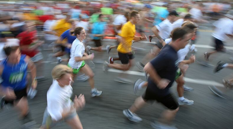 Runners are a blur of motion and color in their team shirts as they start the 27th annual Kaiser Permanente Corporate Run/Walk down Capitol Avenue on Thursday, Sept. 10, 2009. The event is designed to promote health and fitness among metro-Atlanta companies and their employees. CURTIS COMPTON, CCOMPTON@AJC.COM