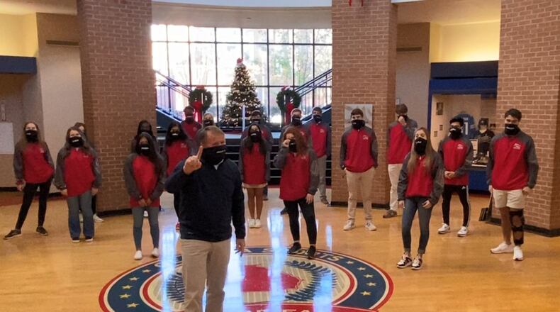 GHSA executive director Robin Hines conducts the association’s universal coin toss from the Georgia Sports Hall of Fame in Macon. He’s joined by the GHSA’s student-athlete advisory committee members.