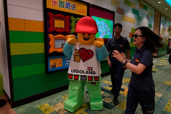 A mascot reacts to visitors at the hotel in Legoland Shanghai a day before it opens to the public in Shanghai, China, Friday, July 4, 2025. (AP Photo/Ng Han Guan)