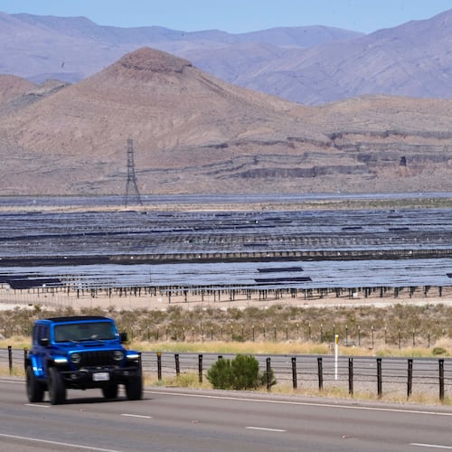 Solar panels stretch out across the desert floor, Thursday, April 2, 2026, in North Las Vegas. (AP Photo/Ty ONeil)