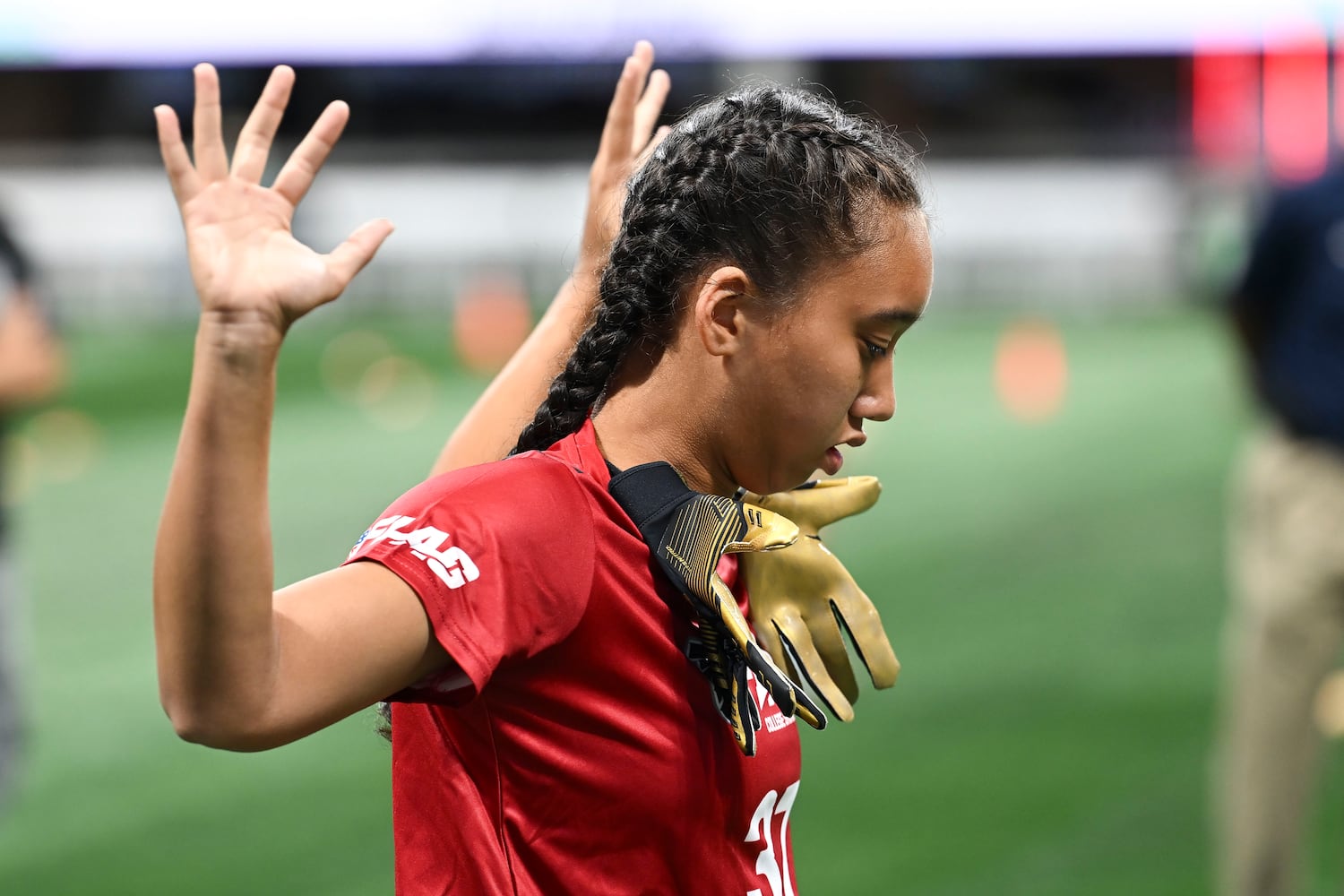 Kaylee Wang stretches while attending the 5th annual Girls Flag Football Showcase. (Daniel Varnado for the AJC)