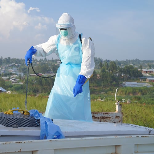 A health worker sprays the coffin containing the remains of Jacques Lobo Dhena, who died of Ebola, during a burial service in Bunia, Ituri province, eastern Congo, Wednesday, Aug. 12, 2026. (AP Photo/Dieudonne Dirole)