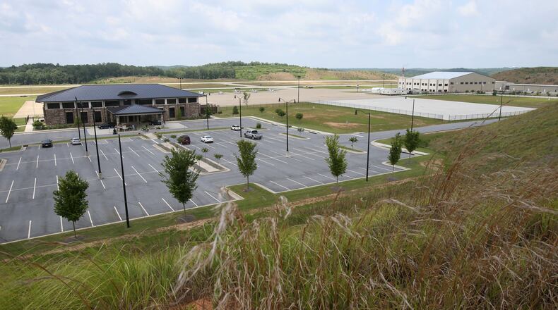 June 25, 2014 - Paulding County - The Paulding County Airport terminal (left) and new hangers (right) viewed from a hill overlooking the airport. Taxi way expansion has been completed, and construction continues in FBO area of Paulding County Airport. First, Delta CEO Richard Anderson said he would fight Paulding County's effort to commercialize its airport. Then residents filed four legal challenges. Now, the city of Atlanta is threatening legal action, saying Paulding, which purchased land from Atlanta for the airport back in 2007, is in breach of contract on that deal. Paulding officials deny that and say Atlanta's opposition flies in the face of the regionalism that Mayor Kasim Reed spoke about to leaders there a few years ago. BOB ANDRES / BANDRES@AJC.COM