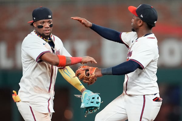Atlanta Braves' Ronald Acuña Jr. and Ozzie Albies, from left, celebrate a win over the San Francisco Giants inning of a baseball game, Monday, July 21, 2025, in Atlanta. (AP Photo/Mike Stewart)