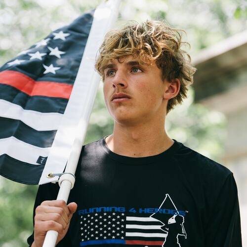 Andrew Collinson, 16, poses for a portrait in the Gainesville Square July 30, 2026, the day before he undertakes his final run for the nonprofit Running 4 Heroes Inc. Collinson has run over 130 miles for the organization, honoring first responders whose lives have been lost in service (Olivia Bowdoin for the AJC).