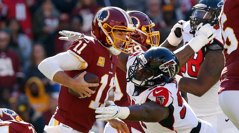 Washington Redskins quarterback Alex Smith (11) is sacked by Atlanta Falcons defensive tackle Grady Jarrett (97) in the first quarter at FedEx Field.