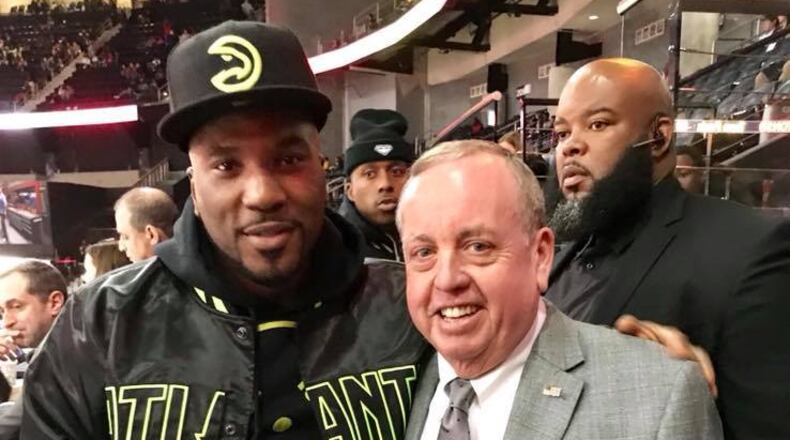 Steve Holman Sr. with Young Jeezy at a recent Hawks game. CREDIT: Steve Holman Sr. provided
