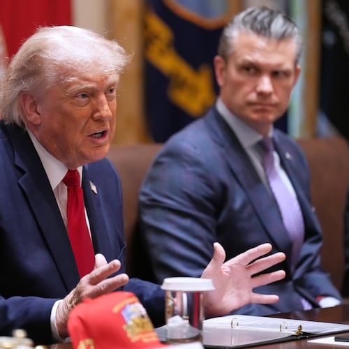 President Donald Trump speaks during a Cabinet meeting at the White House, Wednesday, May 27, 2026, in Washington, as Secretary of Defense Pete Hegseth, looks on. (AP Photo/Jacquelyn Martin)