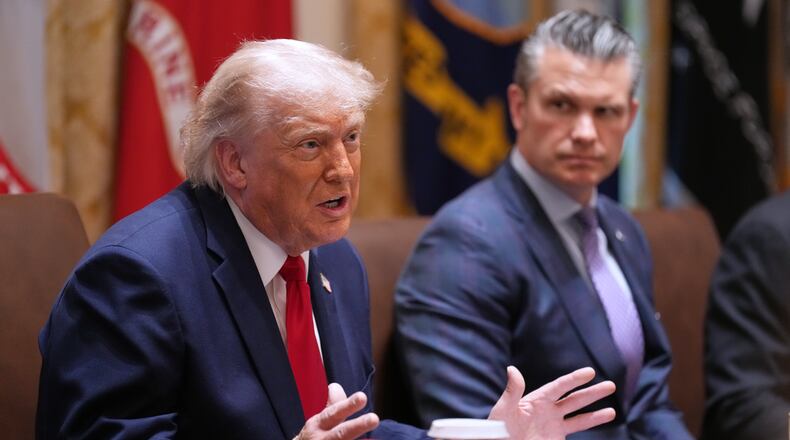 President Donald Trump speaks during a Cabinet meeting at the White House, Wednesday, May 27, 2026, in Washington, as Secretary of Defense Pete Hegseth, looks on. (AP Photo/Jacquelyn Martin)