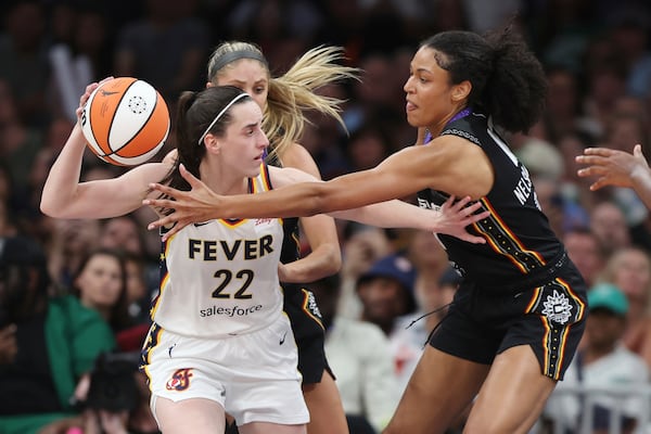 Connecticut Sun's Olivia Nelson-Ododa, right, defends against Indiana Fever's Caitlin Clark (22) during the second half of a WNBA basketball game, Tuesday, July 15, 2025, in Boston. (AP Photo/Michael Dwyer)