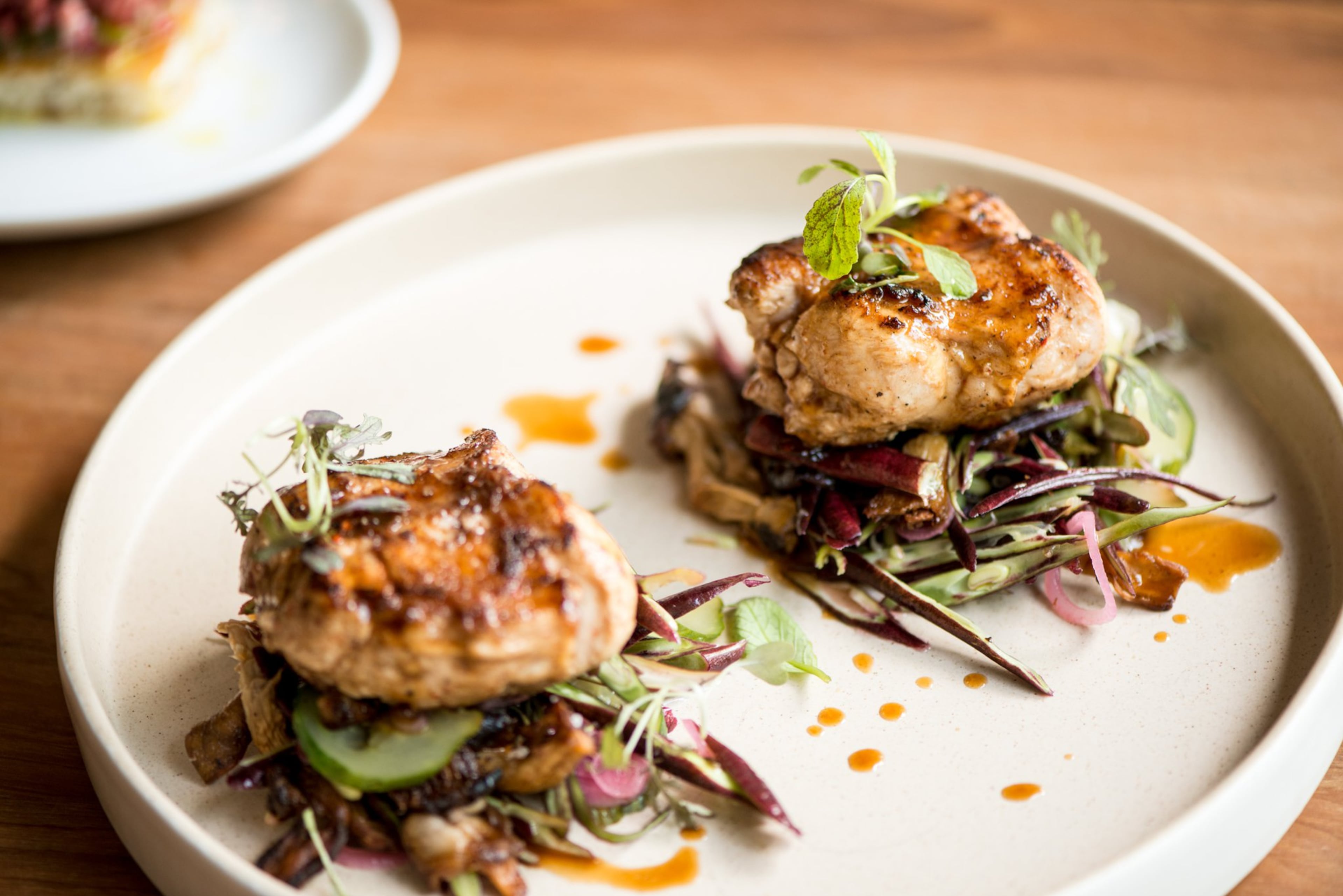 Diners will often find game at the Deer and the Dove, like this miso rabbit loin with long beans, oyster mushrooms, charred cucumber and jus. (Courtesy of Mia Yakel)