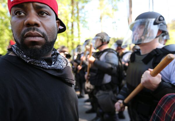 LaJuan Williams turns away from police while taking part in a counter protest at Stone Mountain Park in April 2016. Counter protest organizers said they became aware of Russian attempts to meddle in their event last fall when Twitter and Facebook began deleting Russian false accounts. BEN GRAY / AJC