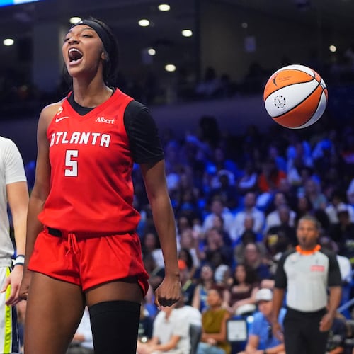 Atlanta Dream forward Angel Reese (5) reacts to scoring with teammate Rhyne Howard (10) during the second half of a WNBA basketball game against the Dallas Wings in Arlington, Texas, Wednesday, July 29, 2026. (AP Photo/LM Otero)