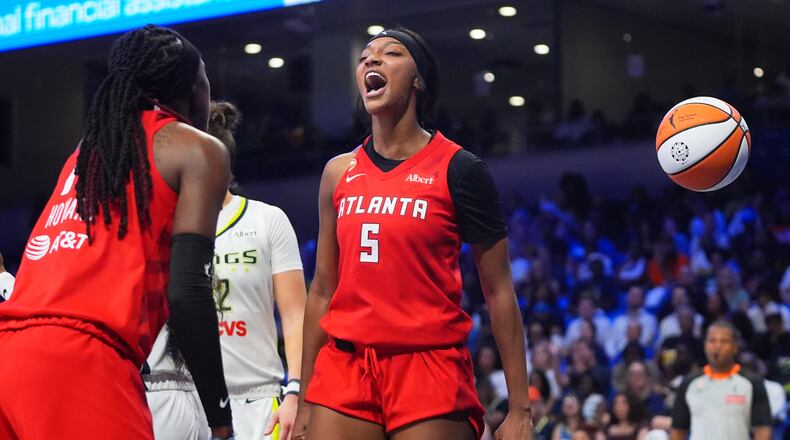 Atlanta Dream forward Angel Reese (5) reacts to scoring with teammate Rhyne Howard (10) during the second half of a WNBA basketball game against the Dallas Wings in Arlington, Texas, Wednesday, July 29, 2026. (AP Photo/LM Otero)