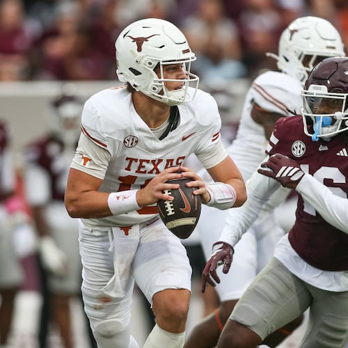Texas quarterback Arch Manning, left, scrambles out of the pocket against Mississippi State linebacker Derion Gullette, front right, during the first half of an NCAA college football game in Starkville, Miss., Saturday, Oct. 25, 2025. (AP Photo/James Pugh)
