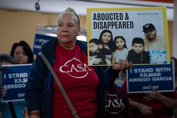 Supporters hold up signs as Jennifer Vasquez Sura, the wife of Kilmar Abrego Garcia of Maryland, who was mistakenly deported to El Salvador, speaks during a news conference at CASA's Multicultural Center in Hyattsville, Md., Friday, April 4, 2025. (AP Photo/Jose Luis Magana)