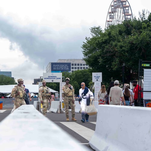 National Guard members stand at the entrance of the Great American State Fair on the National Mall, Saturday June 27, 2026, in Washington. (AP Photo/Jen Golbeck)