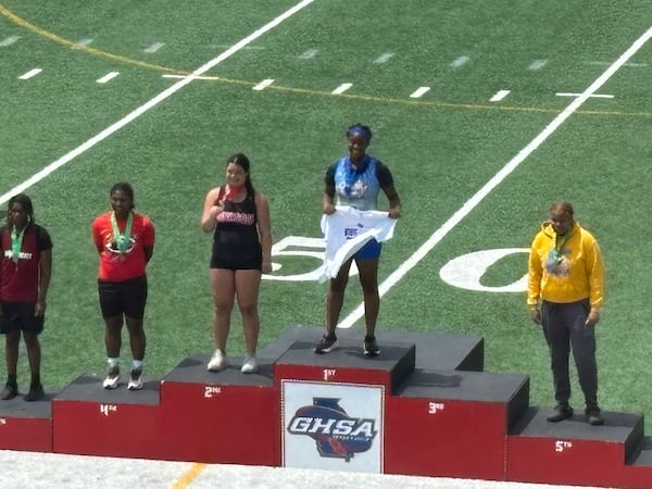 Sierra Thorton of Chamblee shows off her gold medal on the platform at the state meet. The freshman won the Class 5A discus title May 9, 2025. (Stan Awtry/for the AJC)