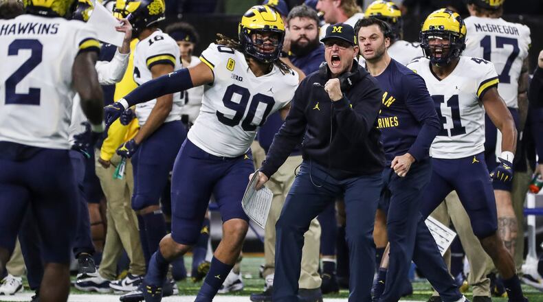 Michigan head coach Jim Harbaugh celebrates a play against Iowa during the first half of the Big Ten championship game at Lucas Oil Stadium on Saturday, Dec. 4, 2021, in Indianapolis. (Kirthmon Dozier/Detroit Free Press/TNS)