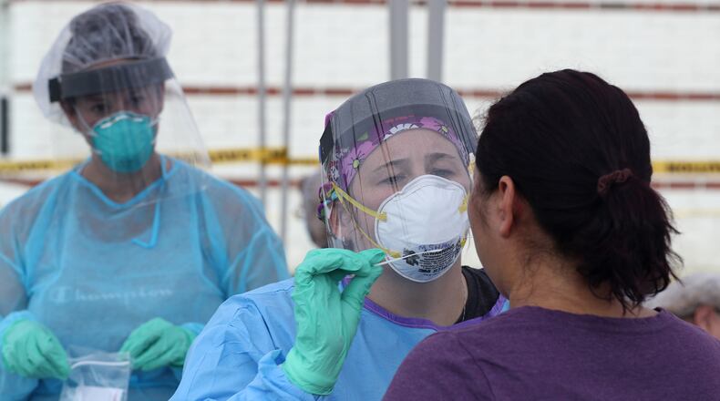 A woman has a COVID-19 test Wednesday at the Clark County Combined Health District's free COVID testing clinic at Hayward Middle School. BILL LACKEY/STAFF
