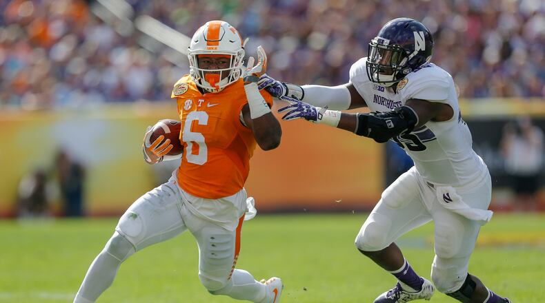 Alvin Kamara of Tennessee avoids a tackle by Drew Smith of Northwestern during the Outback Bowl at Raymond James Stadium on January 1, 2016 in Tampa, Florida. (Photo by Mike Carlson/Getty Images)