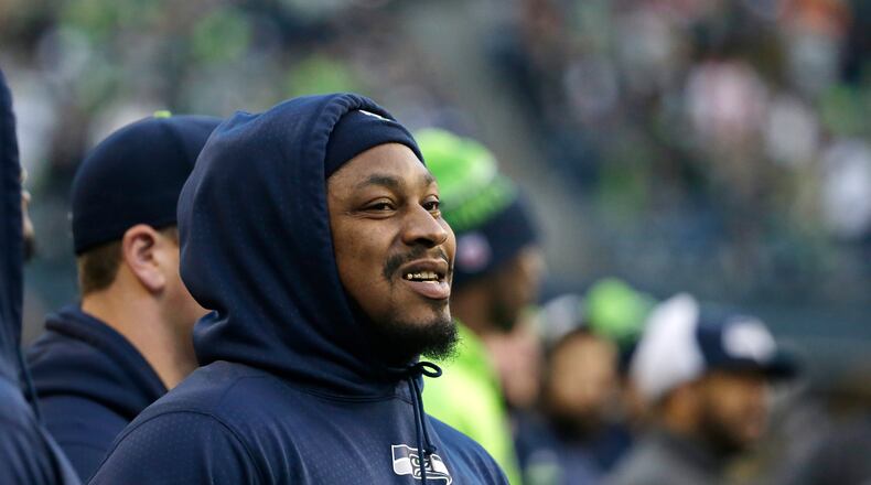 Seattle Seahawks running back Marshawn Lynch watches from the sideline during an NFL football game against the San Francisco 49ers, Sunday, Nov. 22, 2015, in Seattle. Lynch did not play in the game. (AP Photo/Elaine Thompson)