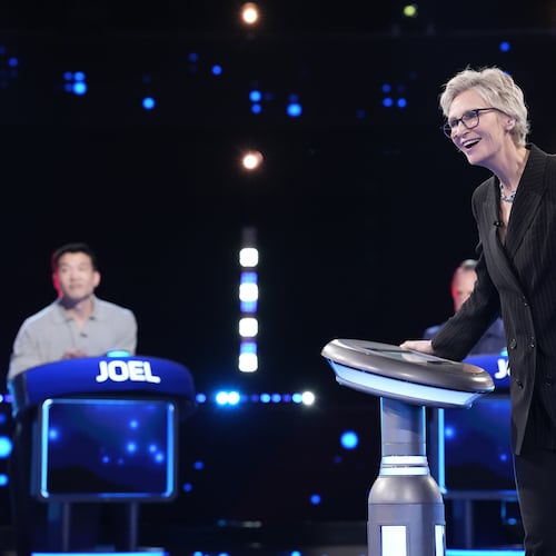 Jane Lynch (right) hosts as Joel Kim Booster competes on Fox’s “Celebrity Weakest Link.” The trivia game show is the latest in an array of primetime game shows coming to metro Atlanta. (Greg Gayne/Fox 2025)