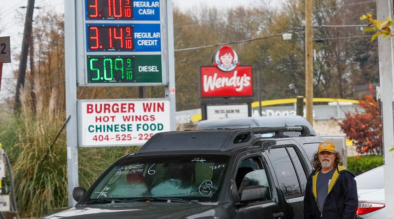 Charlie Laster fills up his tank with gas in East Atlanta Saturday, Dec. 10, 2022. (Steve Schaefer/steve.schaefer@ajc.com)