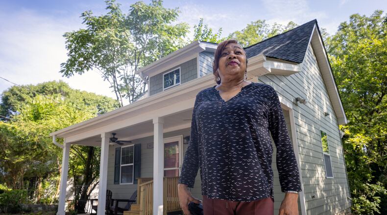 Deborah Glover stands in front of the new home that she will share with young women and children in need of temporary housing. (Steve Schaefer / steve.schaefer@ajc.com)