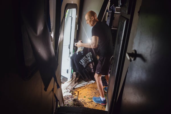 Thomas Rux, a resident of Riverside RV Park, goes through the wreckage of his RV that was swept away by floodwaters in Ingram, Texas, on Friday, July 4, 2025. (Christopher Lee/The San Antonio Express-News via AP)