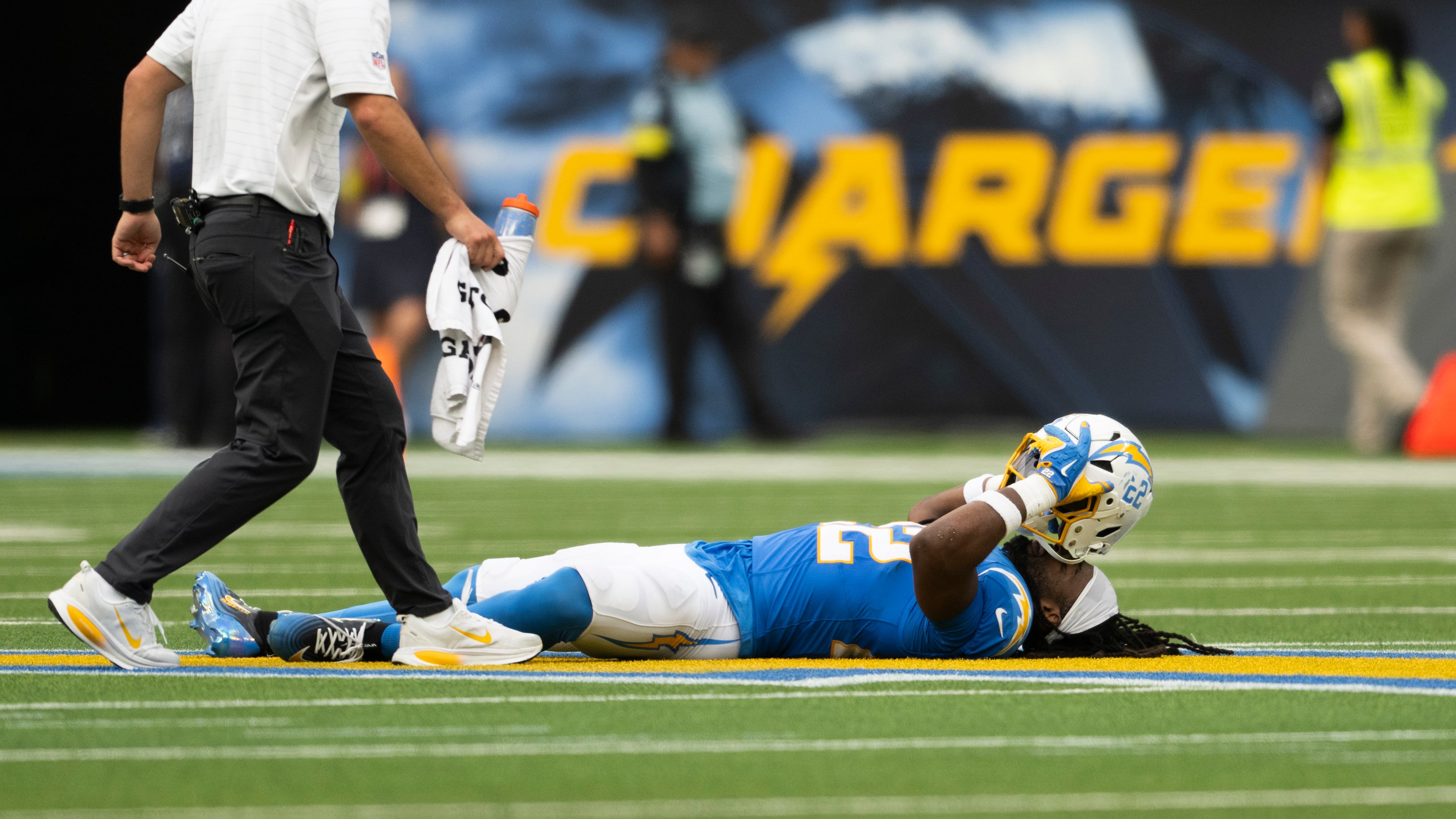Los Angeles Chargers running back Najee Harris, right, lays on the ground after getting injured during an NFL football game against the Denver Broncos, Sunday, Sept. 21, 2025, in Inglewood, Calif. (AP Photo/Kyusung Gong)