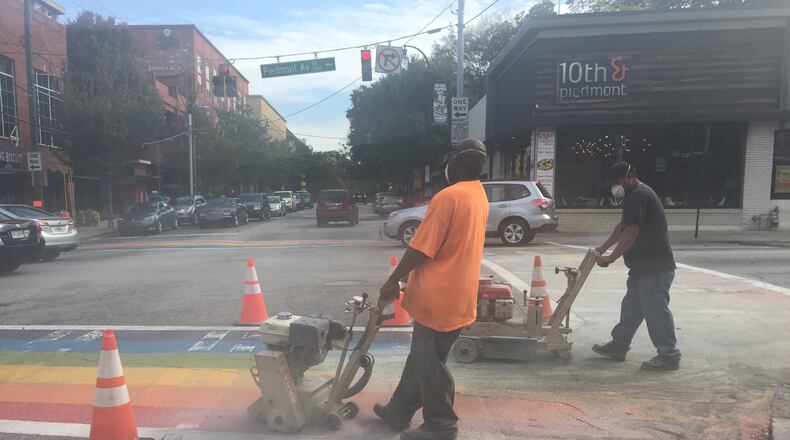 Construction crews on the intersection of 10th and Piedmont in Midtown erase the four rainbow crosswalks installed for Atlanta Pride on Saturday, October 24, 2015.