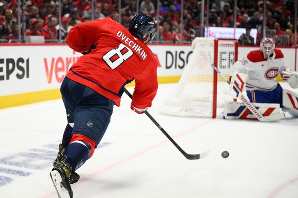 Washington Capitals left wing Alex Ovechkin (8) shoots against Montreal Canadiens goaltender Sam Montembeault (35) in the first period of Game 1 of a first-round NHL hockey playoff series Monday, April 21, 2025, in Washington. (AP Photo/Nick Wass)
