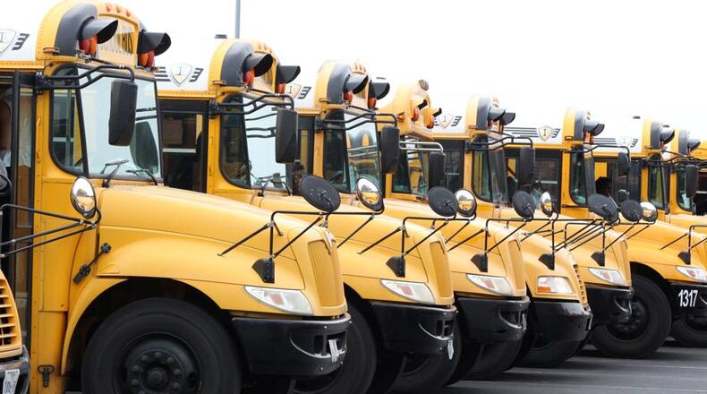 Initial afternoon school bus delays of up to 35 minutes should disappear by the third week of school, Forsyth County School District officials say. AJC FILE