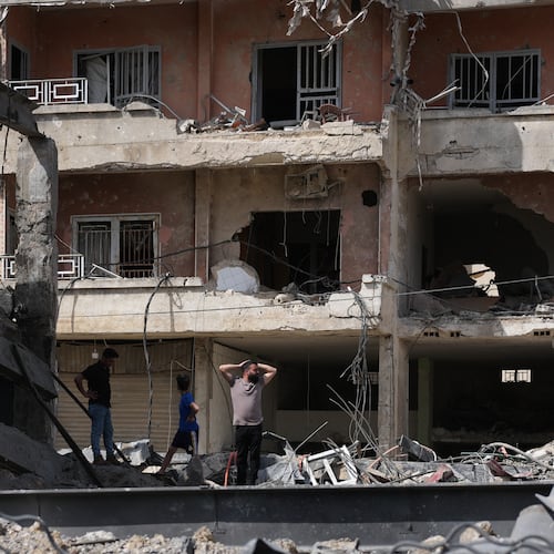 Residents inspect damage at the site of buildings destroyed in Israeli airstrikes, in Jibchit, southern Lebanon, Friday, April 17, 2026, following a ceasefire between Israel and Hezbollah. (AP Photo/Hassan Ammar)