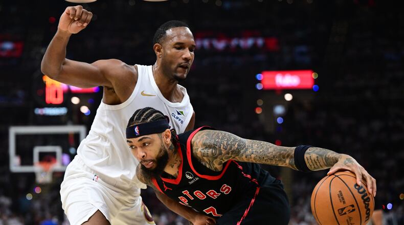 Toronto Raptors forward Brandon Ingram drives on Cleveland Cavaliers center Evan Mobley during the first half in Game 5 of a first-round NBA playoffs basketball series, Wednesday, April 29, 2026, In Cleveland. (AP Photo/David Dermer)