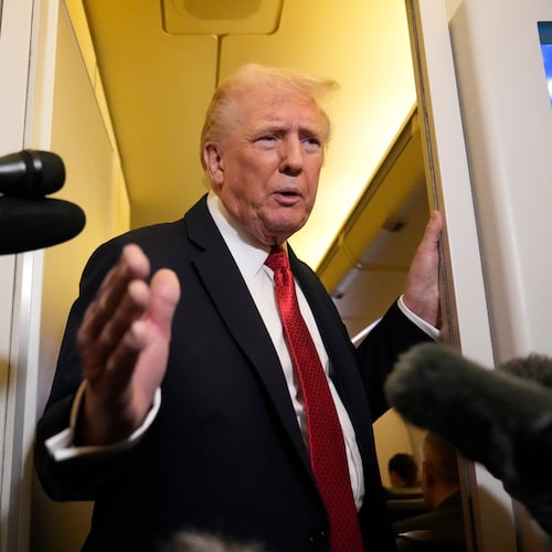 President Donald Trump speaks to reporters aboard Air Force One, Sunday, Oct. 19, 2025, en route to Joint Base Andrews, Md., as he returns from a trip to Florida. (AP Photo/Mark Schiefelbein)