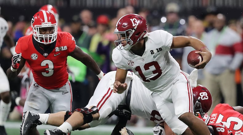 Alabama quarterback Tua Tagovailoa eludes the Georgia pass rush during the third quarter of the national championship. (Curtis Compton/ccompton@ajc.com)