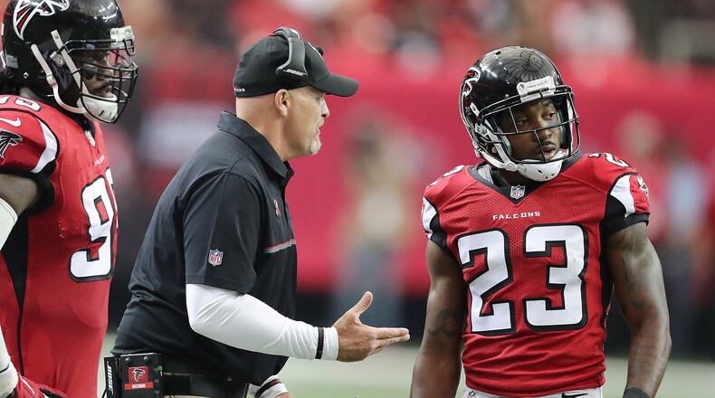 September 11, 2016 ATLANTA: Falcons head coach Dan Quinn confers with cornerback Robert Alford after a penalty by Alford gives the Buccaneers a first down during the third quarter in an NFL football game on Sunday, Sept. 11, 2016, in Atlanta. The Falcons committed several third down penaltys during the game to help advance their opponents. Curtis Compton /ccompton@ajc.com