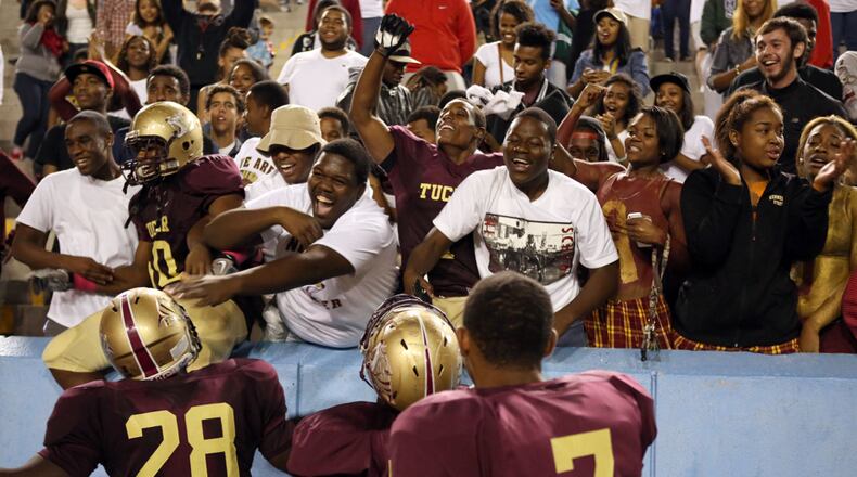 CELEBRATING A WIN--Oct. 11, 2013 - CLARKSTON: Tucker team jumps into the stands to celebrate their down to the wire 31-28 win over Stephenson. (Akili-Casundria Ramsess/Special to the AJC)