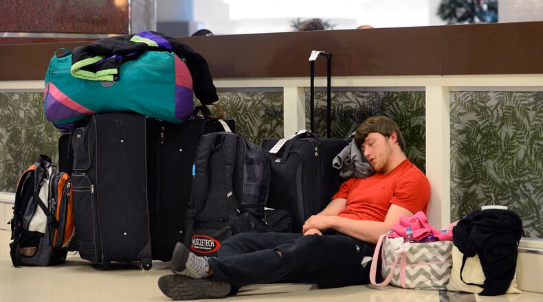 Matt Bell, of Flowery Branch, Ga., rests next to his luggage as he sits out a six-hour delay trying to get to Salt Lake City for a ski trip during an FAA-ordered ground stop at Hartsfield-Jackson International Airport when a winter storm moved into the South bringing a mix of snow, sleet and rain Wednesday, Feb. 25, 2015, in Atlanta. (AP Photo/David Tulis) Matt Bell, of Flowery Branch, Ga., rests next to his luggage as he sits out a six-hour delay trying to get to Salt Lake City for a ski trip during an FAA-ordered ground stop at Hartsfield-Jackson International Airport when a winter storm moved into the South bringing a mix of snow, sleet and rain Wednesday, Feb. 25, 2015, in Atlanta. (AP Photo/David Tulis)
