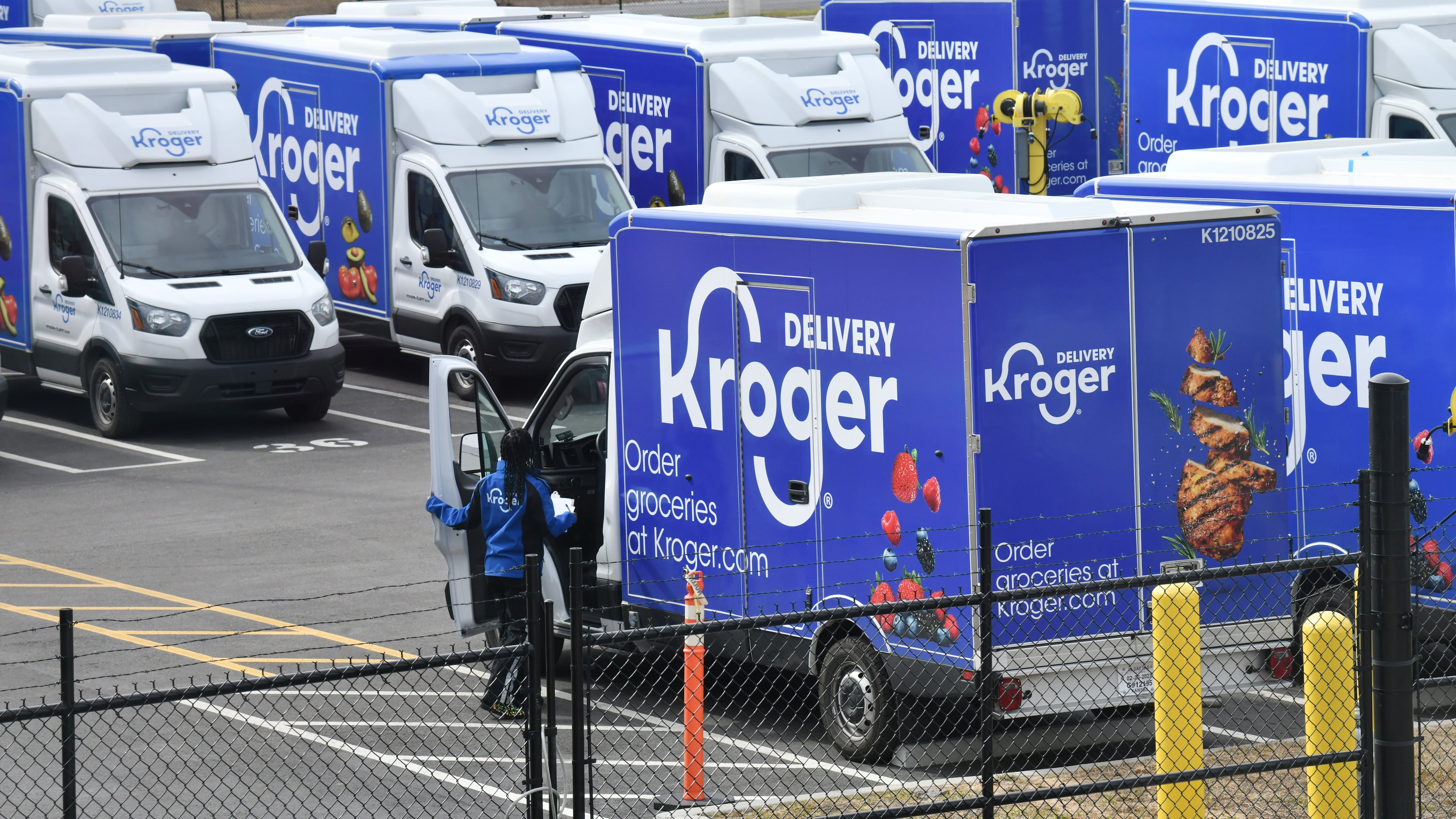 A parking lot is full of Kroger delivery trucks at the Kroger Delivery Atlanta Fulfillment Center in Forest Park.  (Hyosub Shin / AJC)