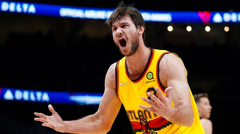 Atlanta Hawks forward Danilo Gallinari (8) reacts after being charged with a foul during the first half of an NBA basketball game against the Miami Heat Wednesday, Jan. 12, 2022, in Atlanta. (AP Photo/John Bazemore)