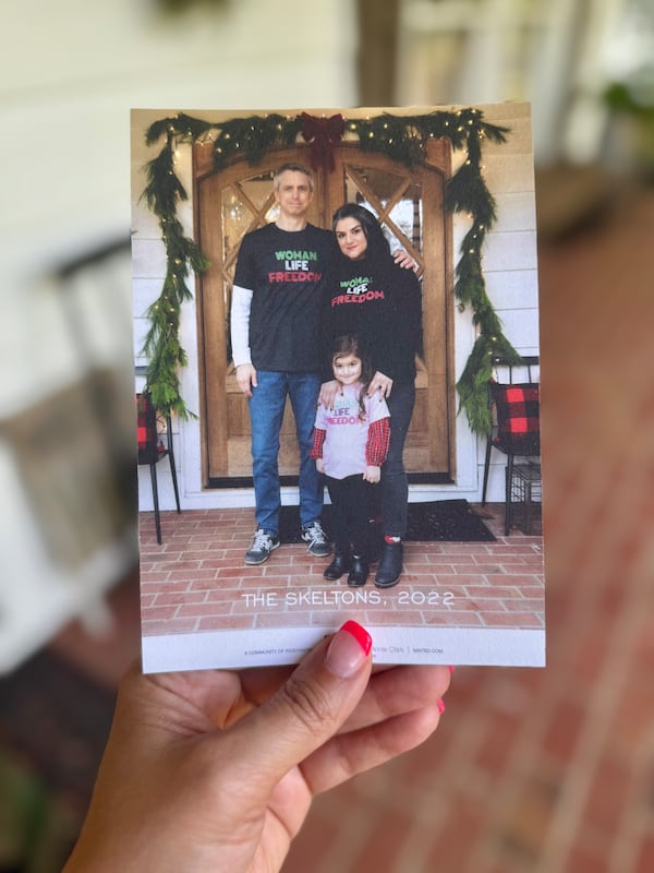 In this 2022 holiday card, Neda Abghari-Skelton of metro Atlanta is pictured with her husband, Brooke Skelton, and their daughter Maryam Elise Skelton, who is now 7. Emblazoned on their shirts are the words "Woman, Life, Freedom" in the colors of the Iranian flag — a nod to the global movement in support of women-led protests in Iran in 2022. (Courtesy)