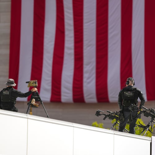 Members of the U.S. Secret Service police conduct overwatch during the IndyCar Freedom 250 Grand Prix auto race, Sunday, Aug. 23, 2026, in Washington. (AP Photo/Julia Demaree Nikhinson)