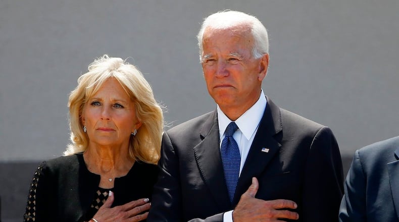 Former Vice President Joe Biden, right, and his wife Jill Biden, pause with hands over their hearts as they watch a military honor guard place the casket of Sen. John McCain, R-Ariz., into a hearse after a memorial service at North Phoenix Baptist Church Thursday, Aug. 30, 2018, in Phoenix. (AP Photo/Ross D. Franklin)